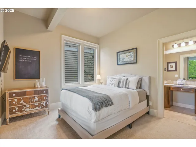 a spacious bedroom with a bed a couch and dresser