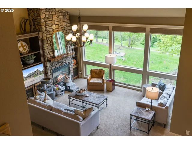 a living room with furniture and a floor to ceiling window