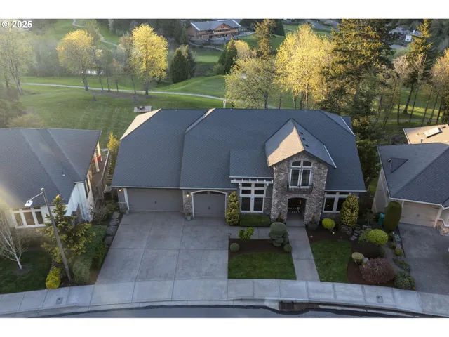 a aerial view of a house next to a big yard