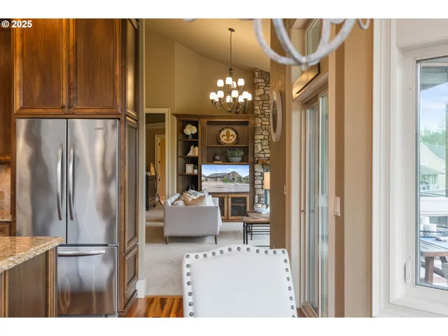 a view of a dining room with furniture a chandelier and wooden floor