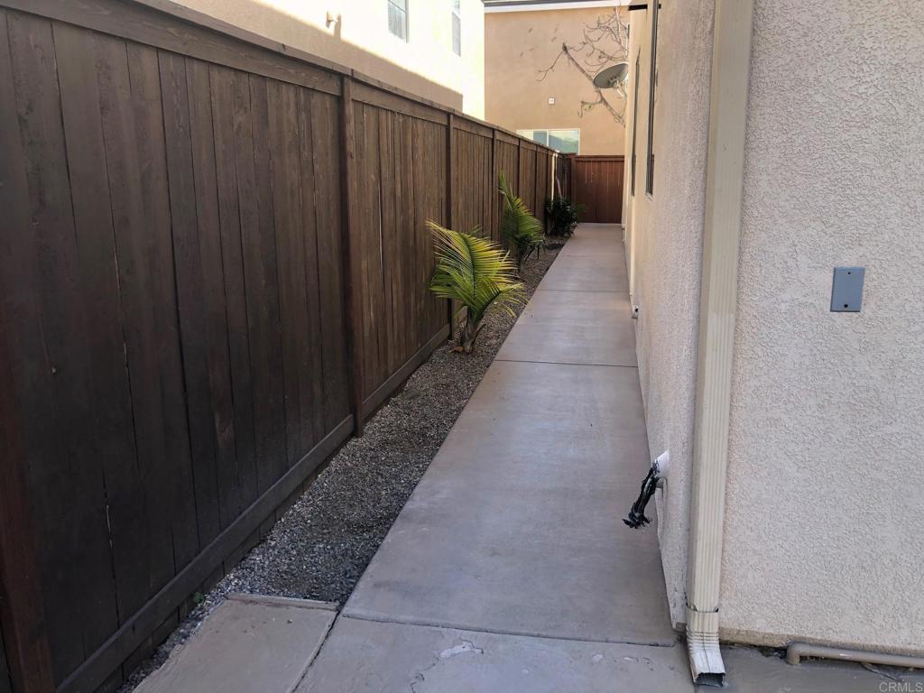 130 Venetia Way Oceanside, CA 92057 - Photo 16 of 19 a view of a pathway with a wooden fence
