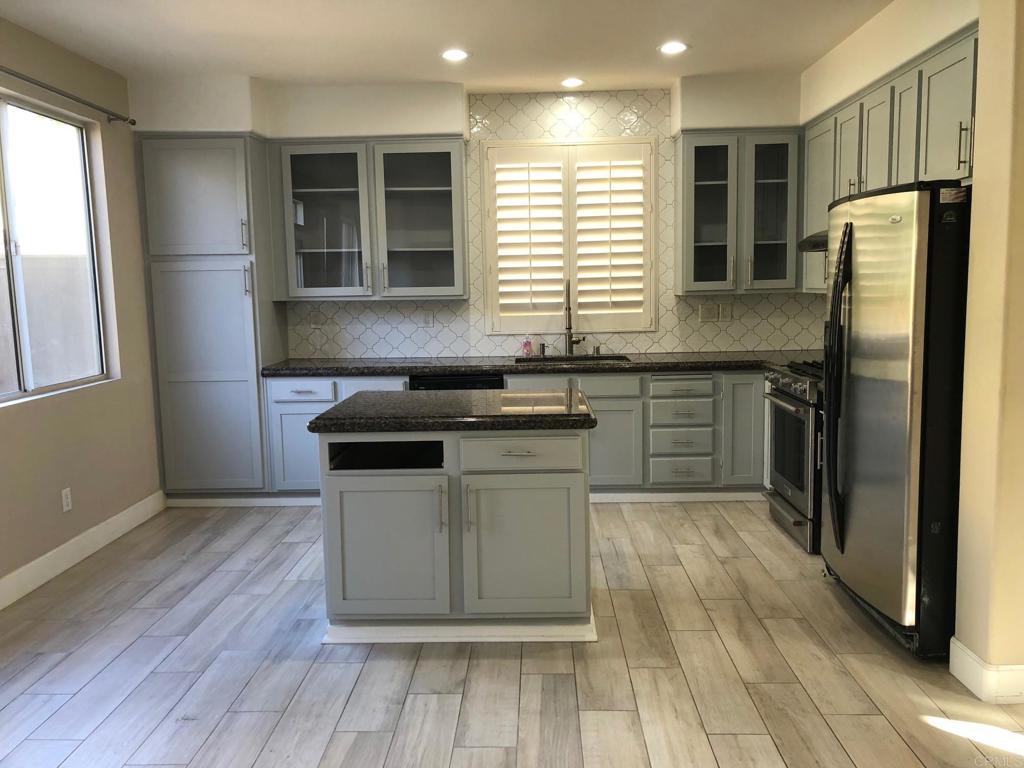 130 Venetia Way Oceanside, CA 92057 - Photo 5 of 19 a kitchen with granite countertop a sink cabinets and stainless steel appliances