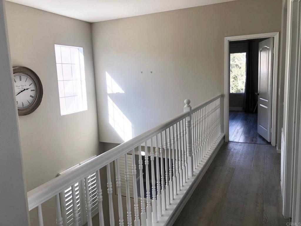 130 Venetia Way Oceanside, CA 92057 - Photo 7 of 19 a view of a hallway with wooden floor