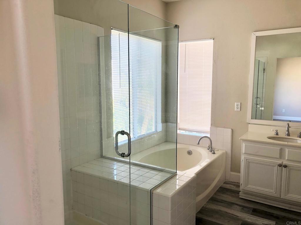 130 Venetia Way Oceanside, CA 92057 - Photo 9 of 19 a bathroom with a tub sink and mirror