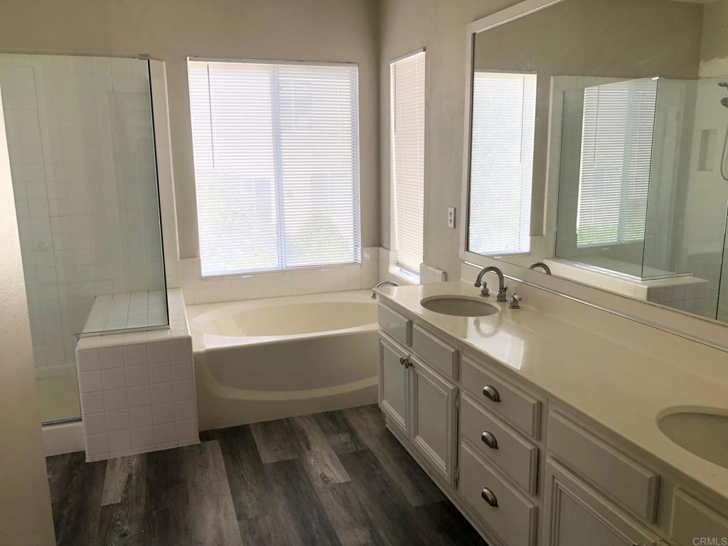130 Venetia Way Oceanside, CA 92057 - Photo 10 of 19 a bathroom with a tub sink and mirror