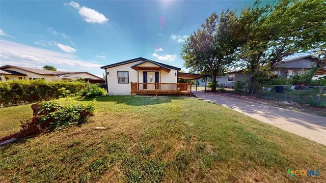 a front view of a house with a yard and pathway