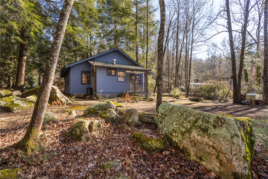 205 Rocky Bottom Road Sunset, SC 29685 - Photo 26 of 46 A secluded wooded setting surrounds this rustic cabin nestled among mature trees and natural boulders.