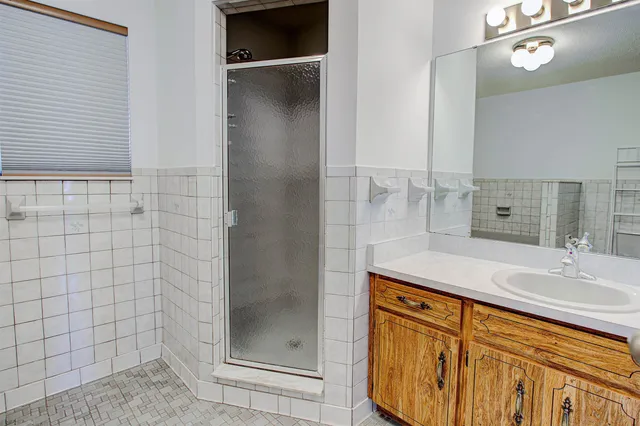 a bathroom with a shower and a sink