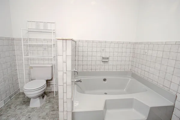 a bathroom with a toilet and a shower