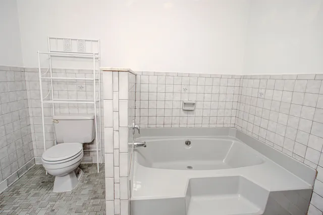 a bathroom with a toilet and a shower