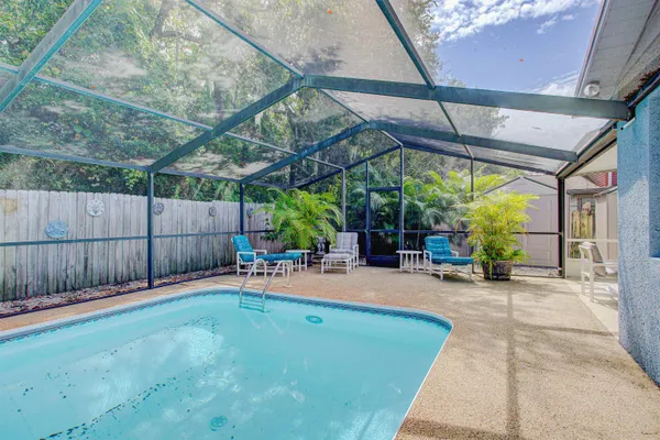 a backyard of a house with table and chairs