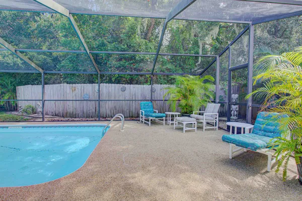 a view of backyard with outdoor seating and green space