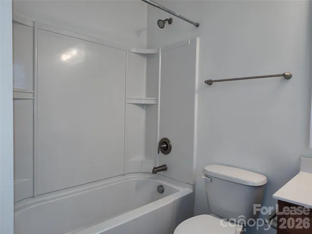 a bathroom with a toilet and a bathtub