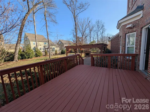 a view of a wooden deck with a yard