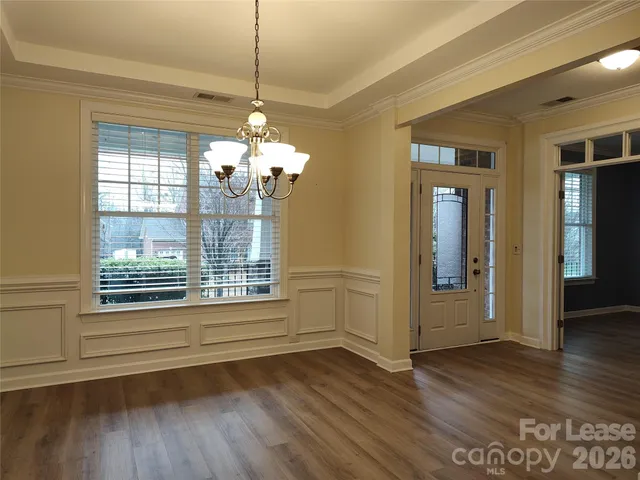 a view of a livingroom with wooden floor and a window