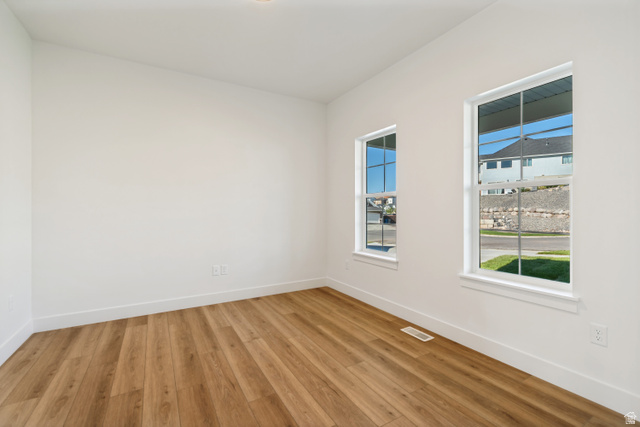 1351 Maple Circle Santaquin, UT 84655 - Photo 7 of 42 Room featuring wood-finish flooring, white baseboards, and two windows providing natural illumination