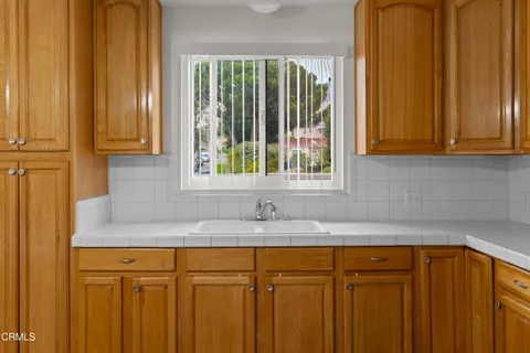 a kitchen with granite countertop wooden cabinets