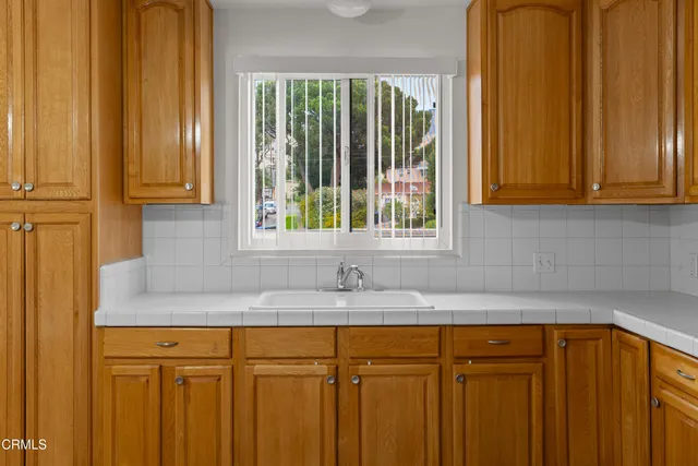 a kitchen with granite countertop wooden cabinets