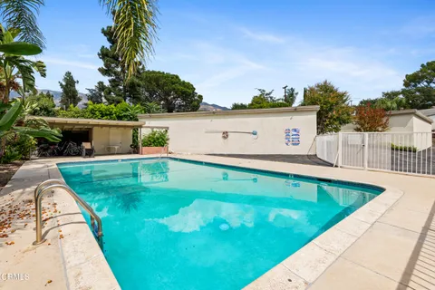 a view of a swimming pool with a yard