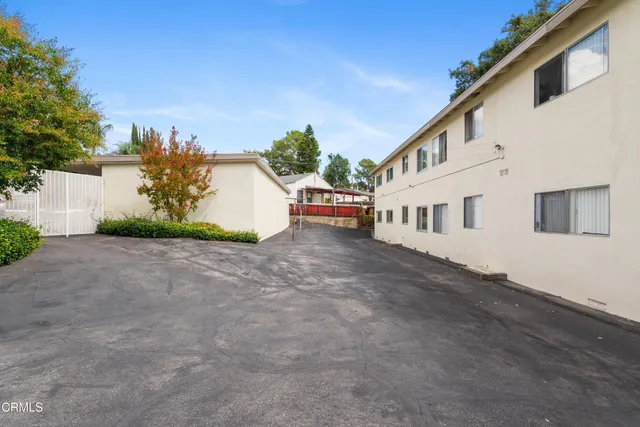 a view of a white house with a yard