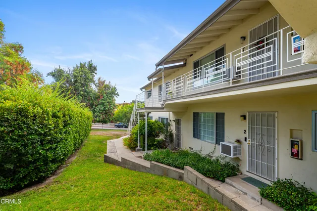 a view of a house with a yard and plants