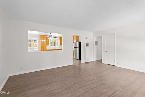 a view of an empty room with closet and a window