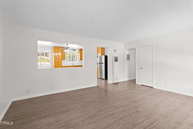 a view of an empty room with closet and a window