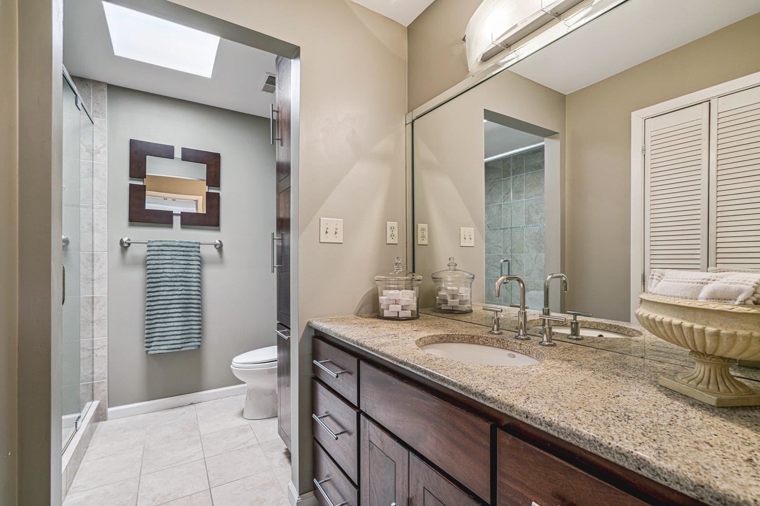 335 Riverbluff Place, Unit 2 Memphis, TN 38103 - Photo 13 of 21 a bathroom with a granite countertop sink and a mirror