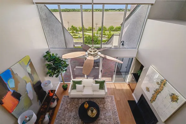 a living room with furniture and a floor to ceiling window