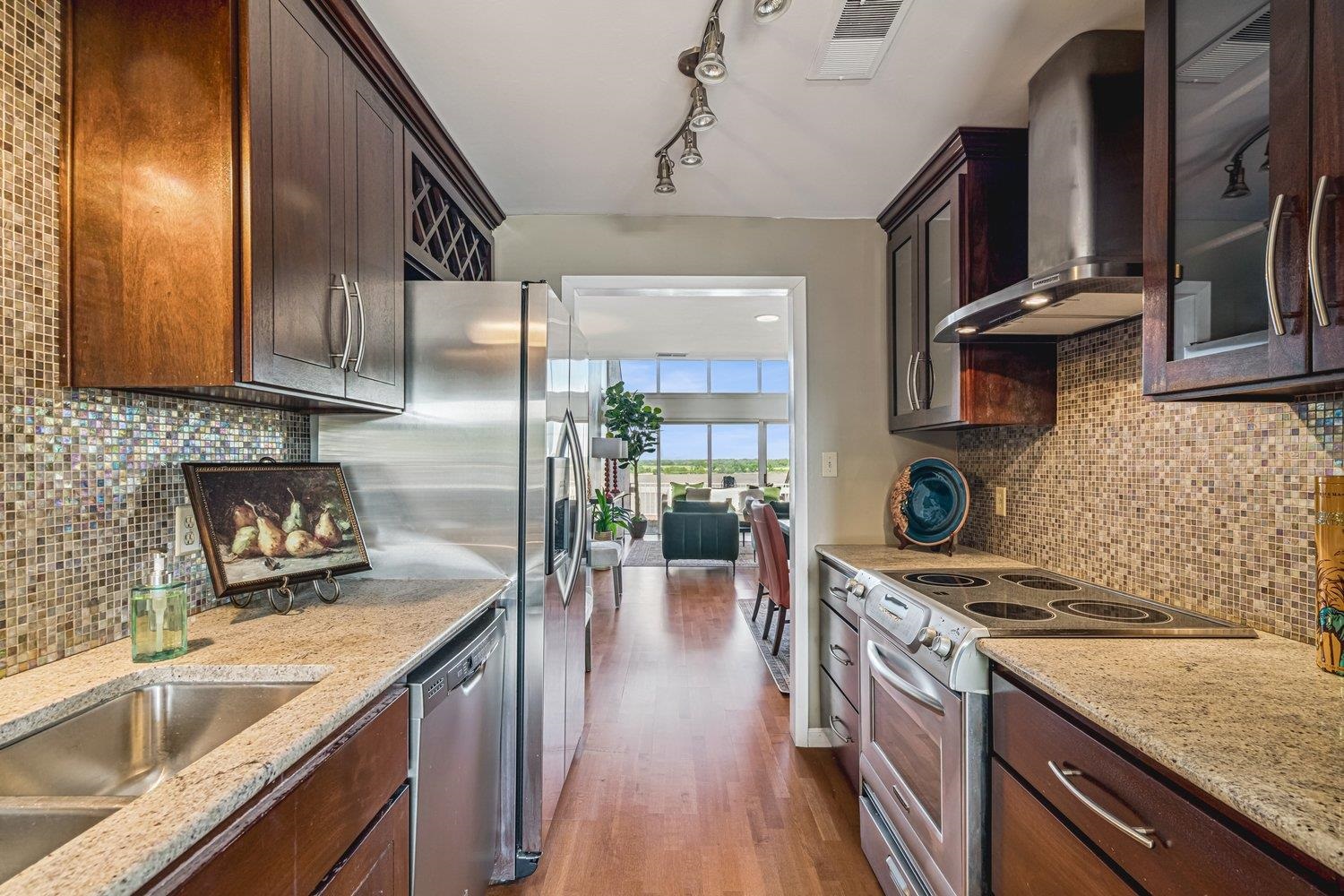 335 Riverbluff Place, Unit 2 Memphis, TN 38103 - Photo 9 of 21 a kitchen with stainless steel appliances granite countertop a sink a stove and a wooden floors