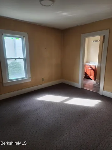 a bathroom with a tub shower vanity and a sink