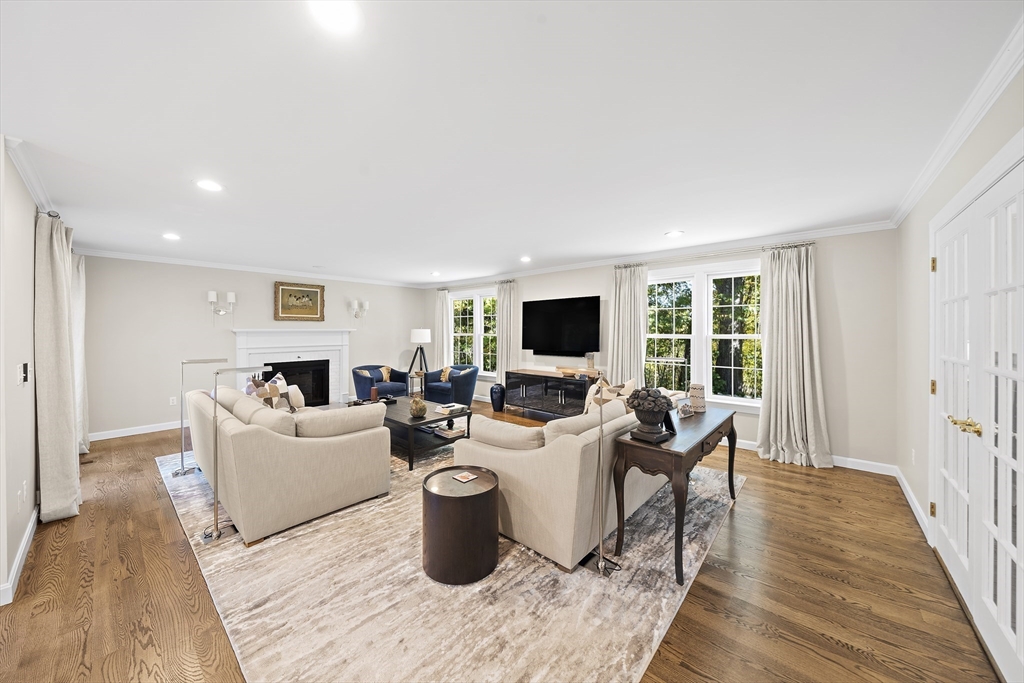 48 Lexington Circle Holden, MA 01520 - Photo 15 of 42 a living room with furniture a flat screen tv and a large window