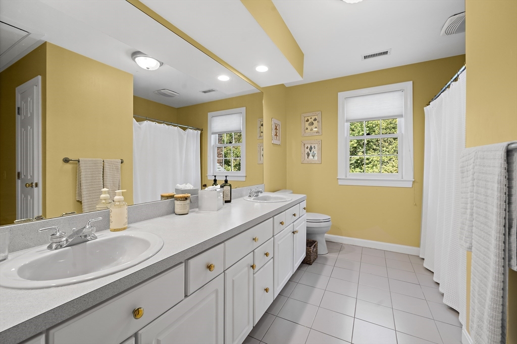48 Lexington Circle Holden, MA 01520 - Photo 26 of 42 a spacious bathroom with a double vanity sink a mirror and a bathtub