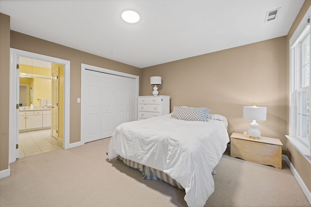 48 Lexington Circle Holden, MA 01520 - Photo 27 of 42 a spacious bedroom with a bed and a cabinets