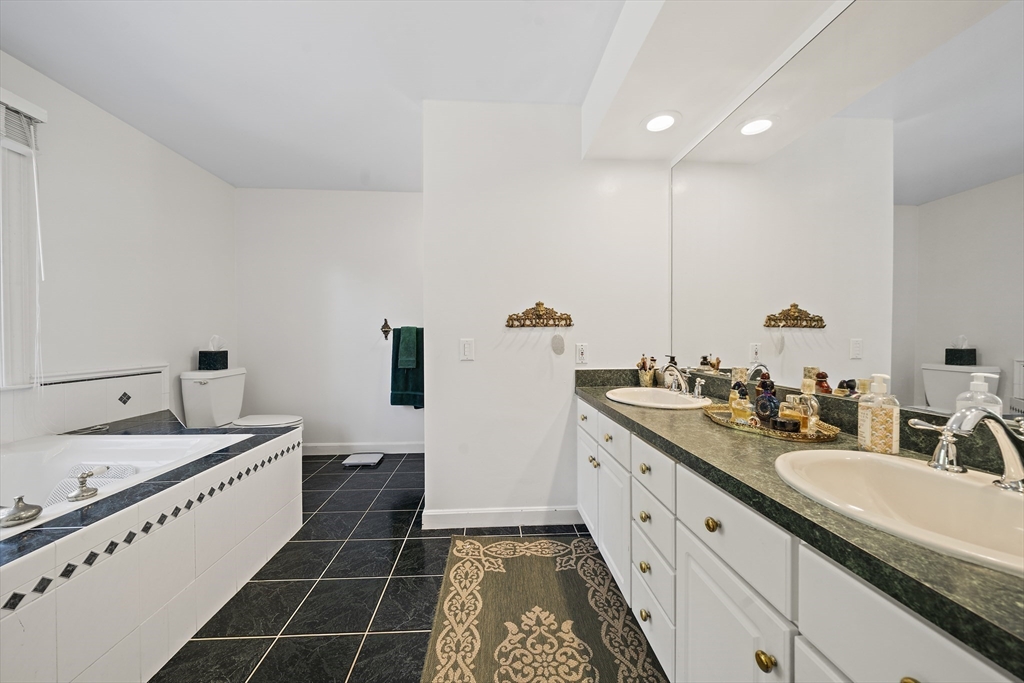 48 Lexington Circle Holden, MA 01520 - Photo 34 of 42 a spacious bathroom with a double vanity sink a mirror and a bathtub