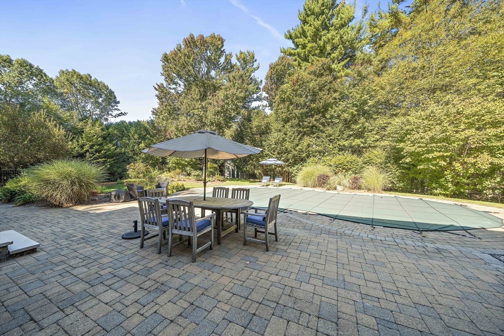 48 Lexington Circle Holden, MA 01520 - Photo 40 of 42 a view of a patio with table and chairs under an umbrella