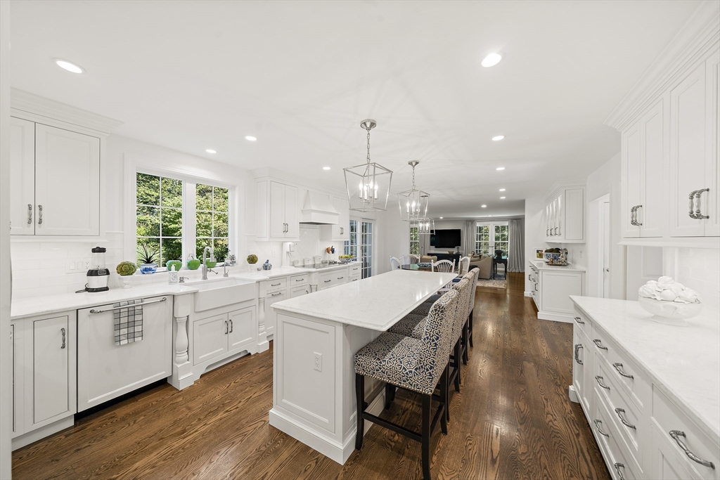 48 Lexington Circle Holden, MA 01520 - Photo 10 of 42 a large kitchen with kitchen island a island a sink a stove a dining table and chairs