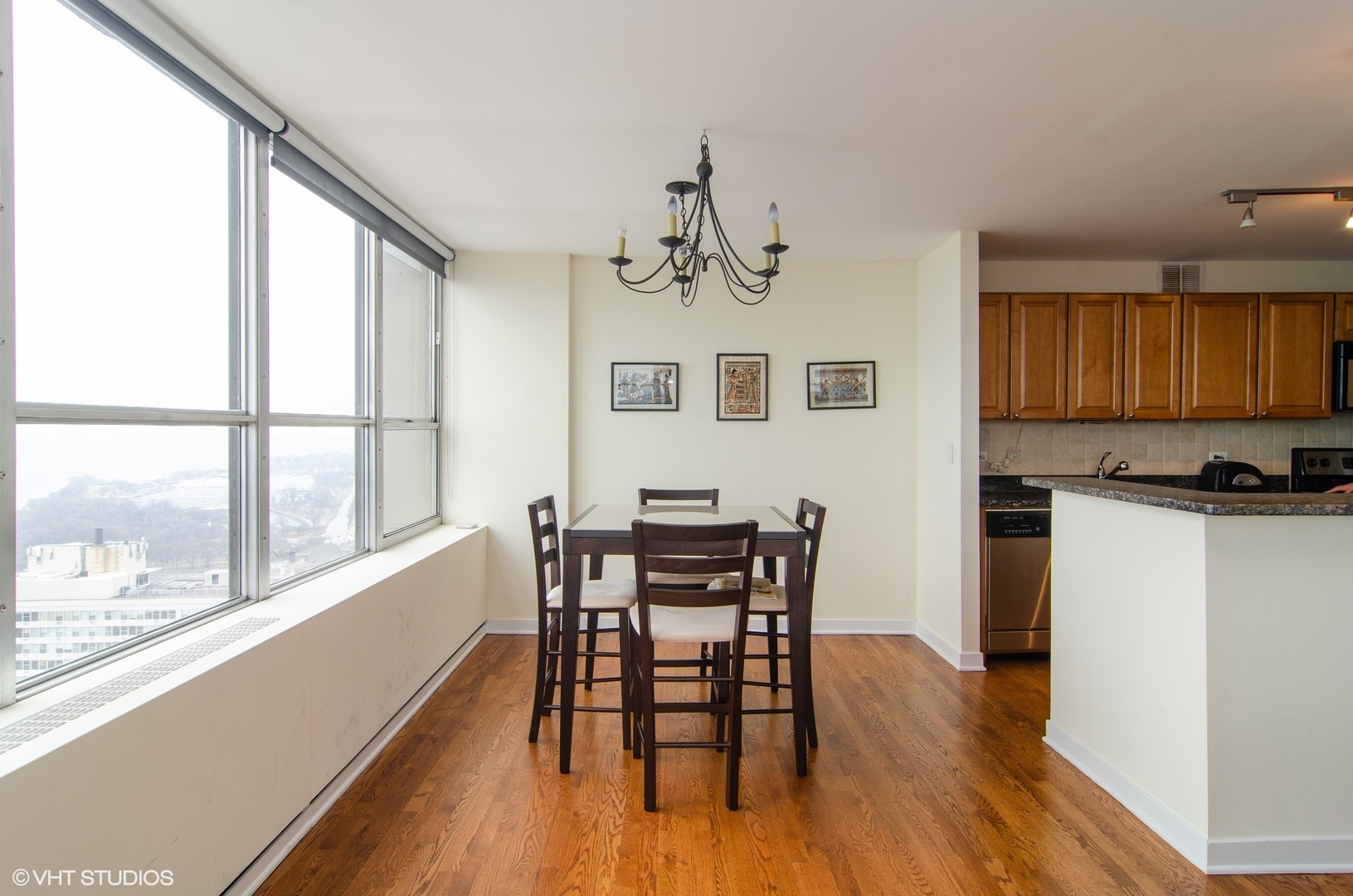 655 West Irving Park Road, Unit 3602 Chicago, IL 60613 - Photo 3 of 24 a view of a dining room with furniture window and wooden floor