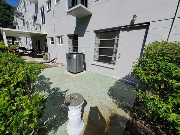 a view of a patio with table and chairs potted plants