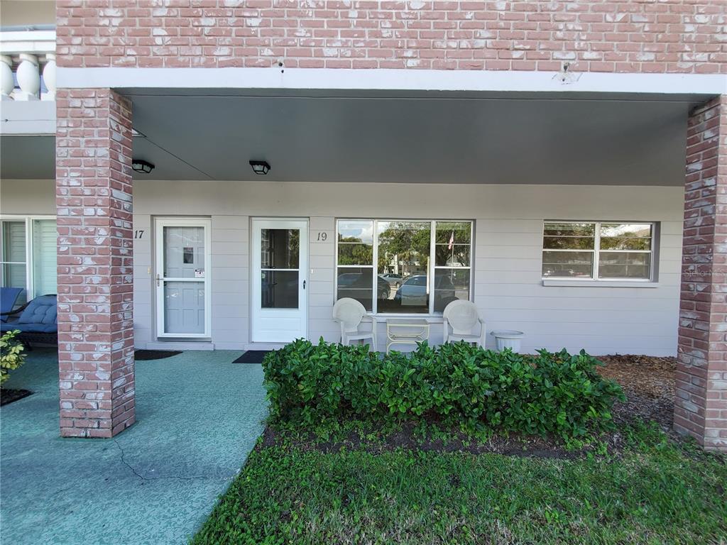 2461 Rhodesian Drive, Unit 19 Clearwater, FL 33763 - Photo 2 of 28 a front view of a house with a garden