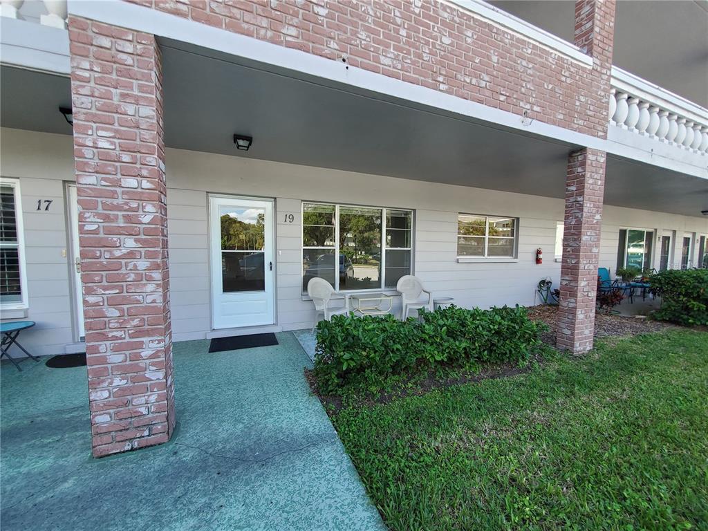 2461 Rhodesian Drive, Unit 19 Clearwater, FL 33763 - Photo 3 of 28 a front view of a house with garden