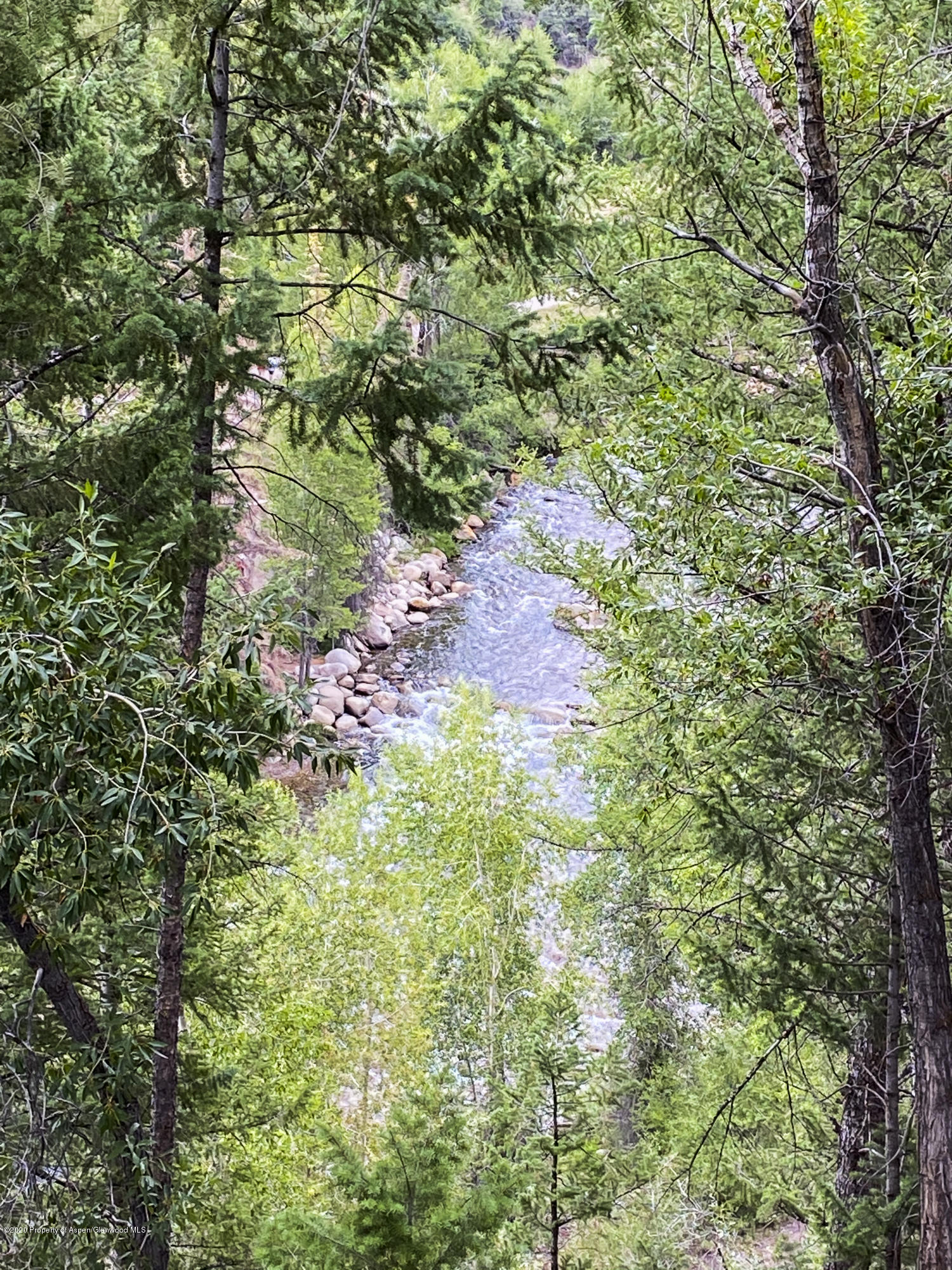 360 Coach Road Aspen, CO 81611 - Photo 12 of 33 a backyard of a house with lots of green space and chair