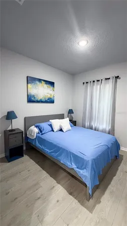 a bedroom with a bed and a couch