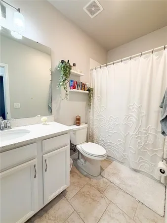 a bathroom with a toilet sink and shower