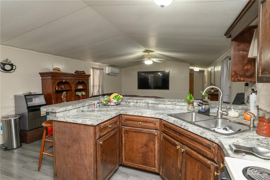 36338 Marshall Hutts Road Rio Hondo, TX 78583 - Photo 13 of 42 a kitchen with a sink and a stove top oven