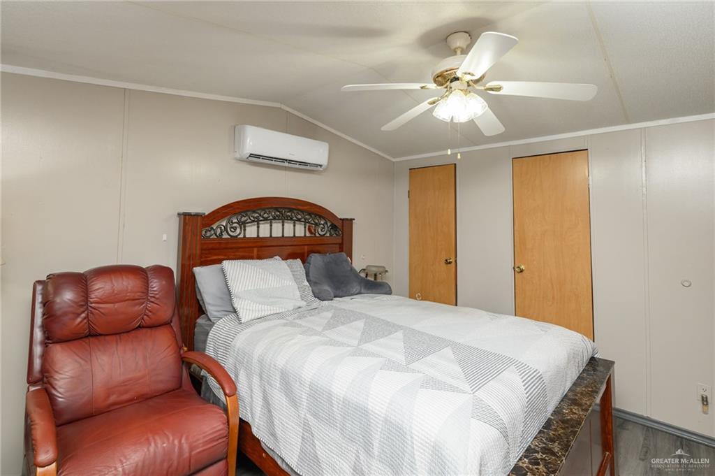 36338 Marshall Hutts Road Rio Hondo, TX 78583 - Photo 14 of 42 a bedroom with a bed couch and a ceiling fan