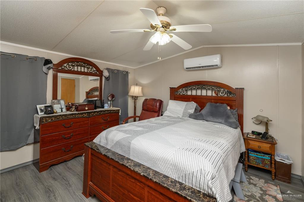 36338 Marshall Hutts Road Rio Hondo, TX 78583 - Photo 15 of 42 a bedroom with bed and a chandelier