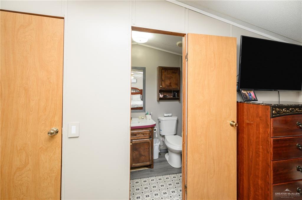 36338 Marshall Hutts Road Rio Hondo, TX 78583 - Photo 17 of 42 a bathroom with a toilet and a shower