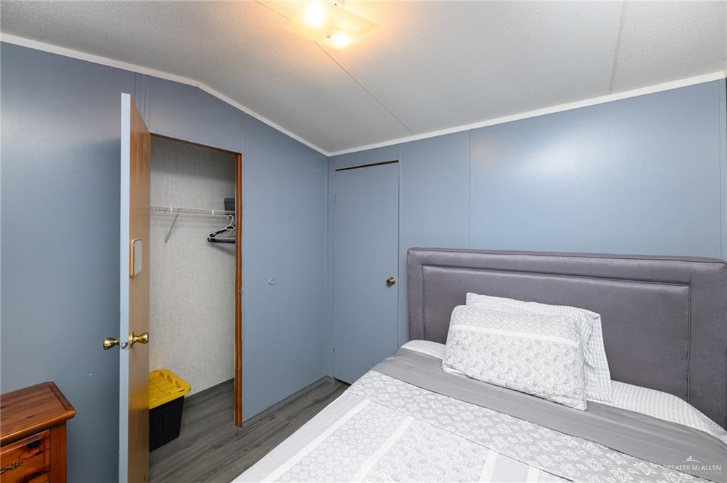 36338 Marshall Hutts Road Rio Hondo, TX 78583 - Photo 20 of 42 a bedroom with a bed and wooden floor