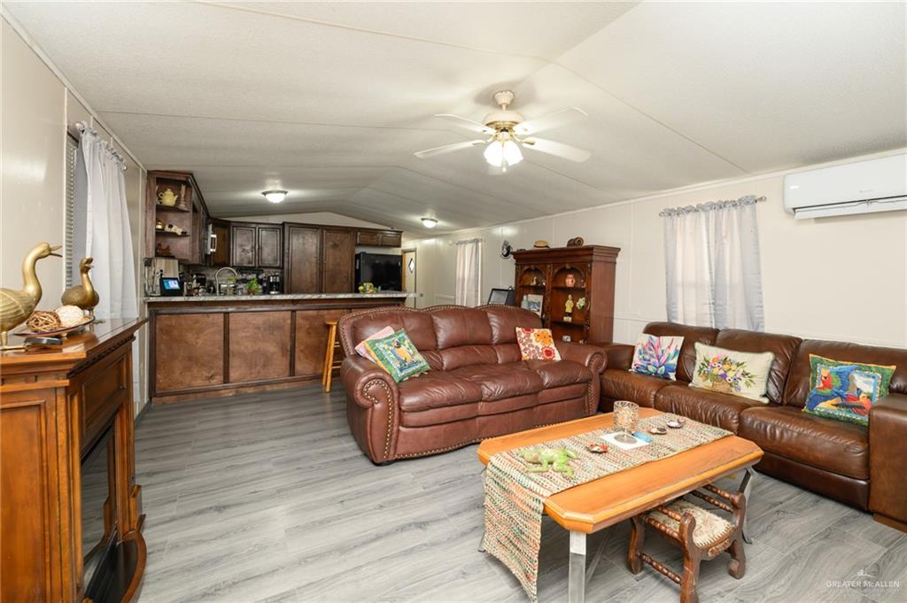 36338 Marshall Hutts Road Rio Hondo, TX 78583 - Photo 2 of 42 a living room with furniture and a wooden floor